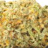 A close up image of a Forbidden Fruit strain marijuana bud on a blank white background