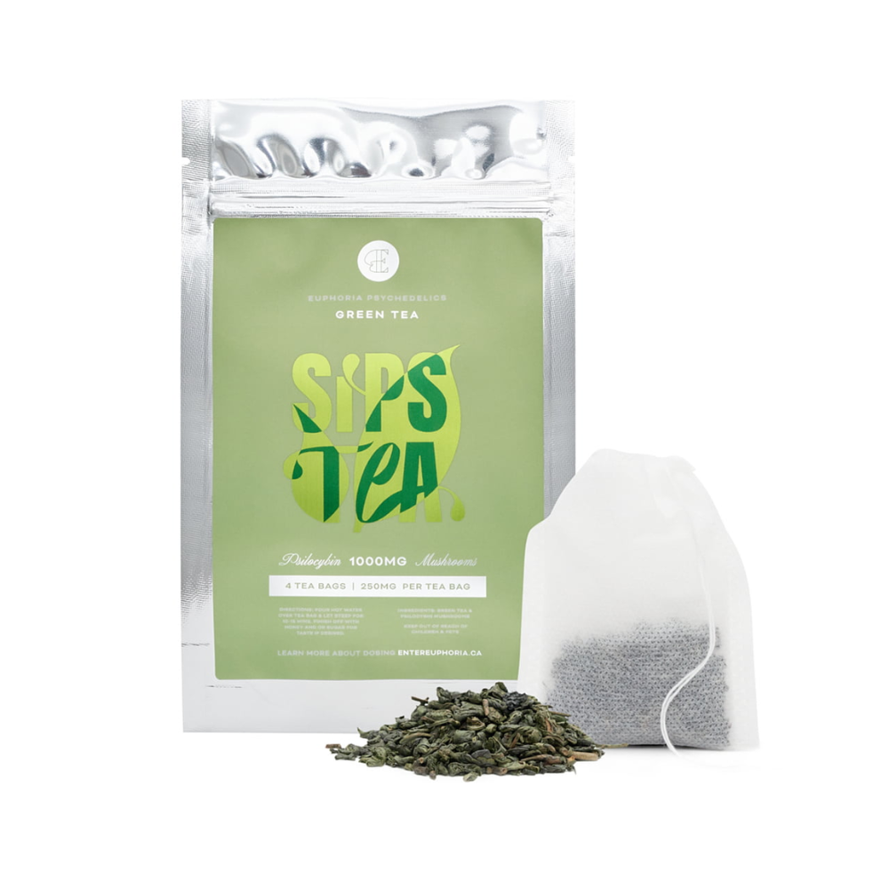 Green Euphoria Psychedelics tea packaging with a single tea bag leaning beside it and a small pile of loose leaf tea in front, all displayed on a clean white background