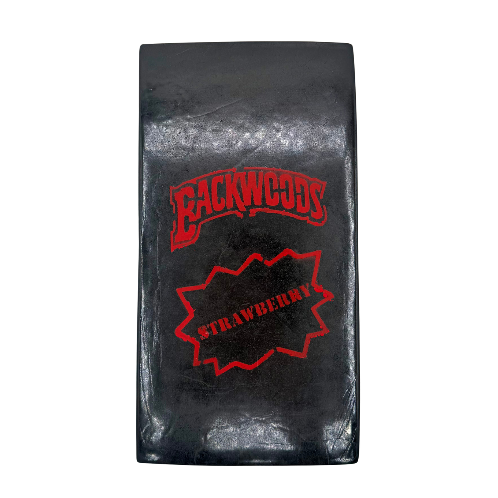 Brick of Strawberry Hash with a "Strawberry Backwoods" red stamp pressed into the surface, propped up on a clean white background